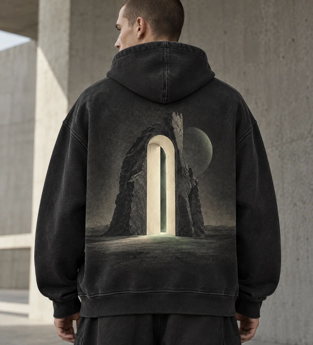 Adult model wearing a washed-black THRESHOLD oversized hoodie with a stone doorway back print